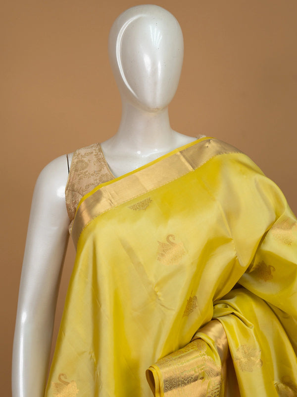 Yellow pure Kanchipuram silk saree with gold zari swan motifs and contrast border