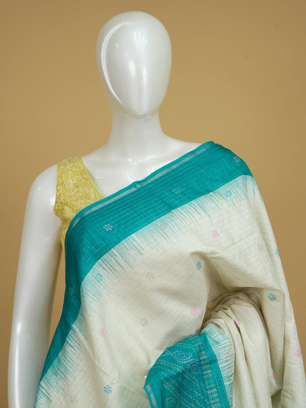 Cream and teal Dola silk saree with contrast temple border, floral buttas and patterned pallu
