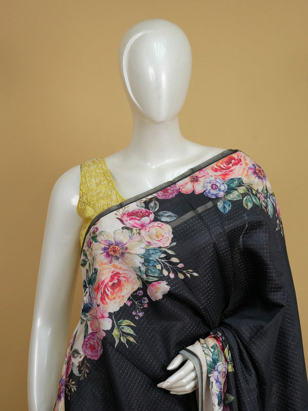 Black semi tussar saree with multicolour floral printed border and pallu on a cream ground