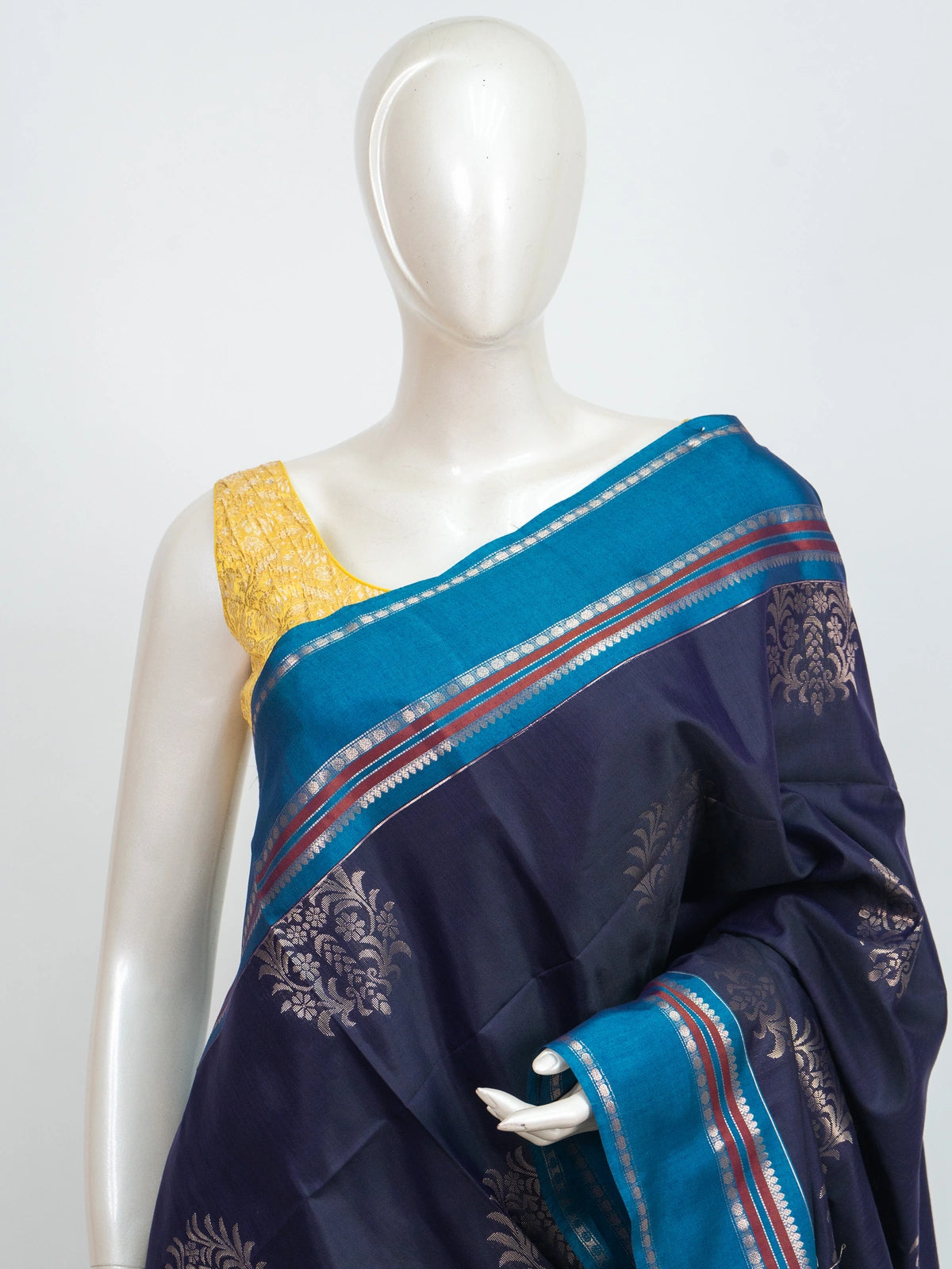 Navy blue Kanchipuram fancy silk saree with peacock blue contrast border and silver zari floral buttas
