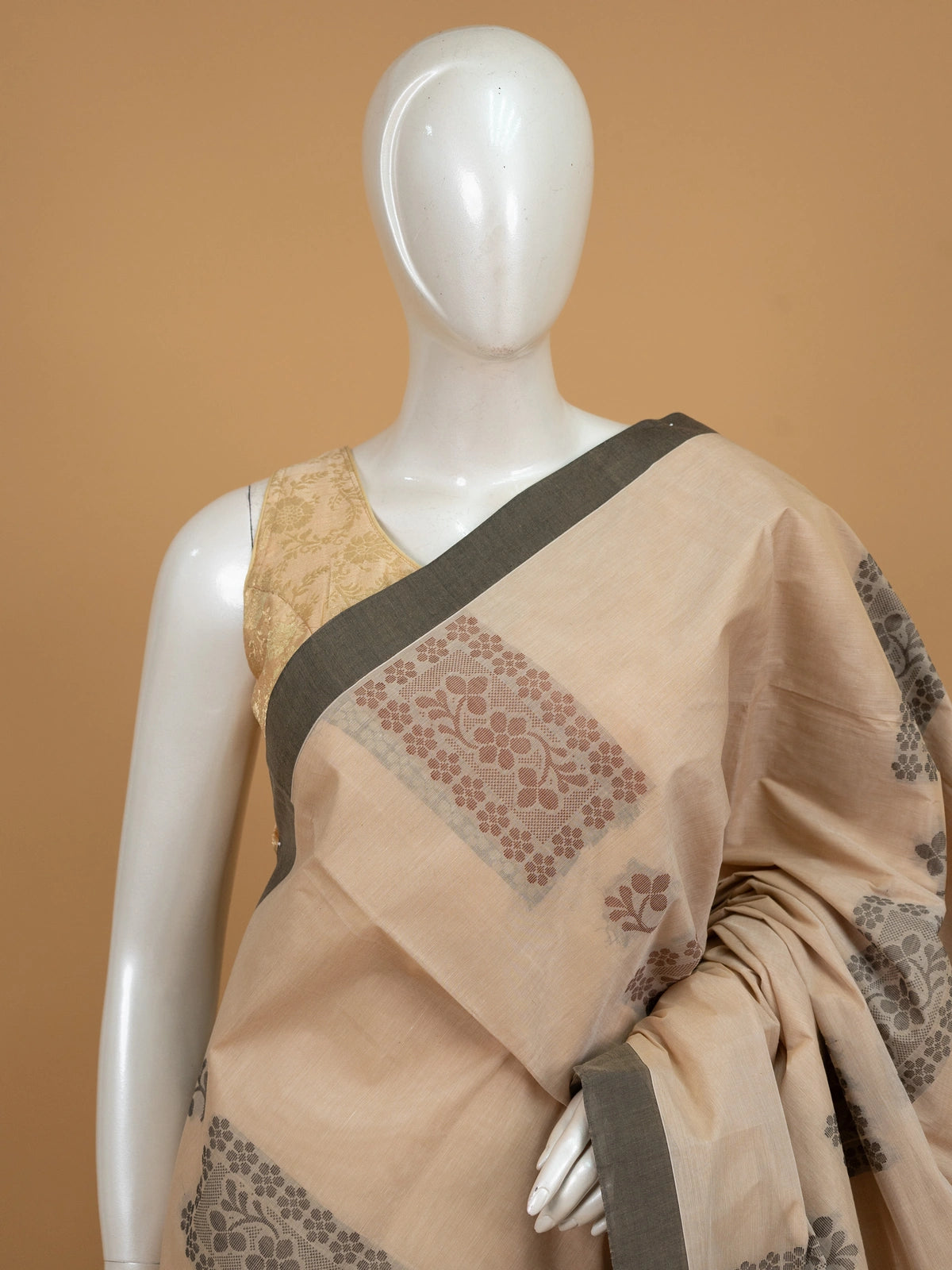 Beige silk cotton saree with grey contrast border and woven floral motifs