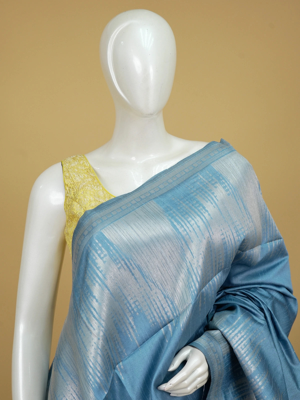 Blue semi tussar saree with silver zari vertical streaks, woven zari border and temple-motif pallu