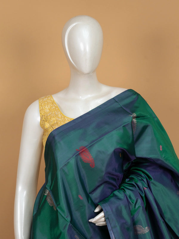 Teal green and pink banana silk saree with paisley butas and striped contrast pallu