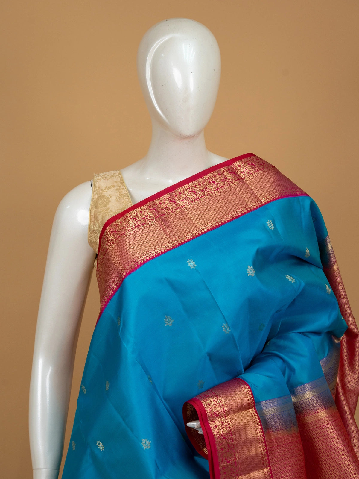 Peacock blue pure Kanchipuram silk saree with contrast pink and gold zari border and pallu