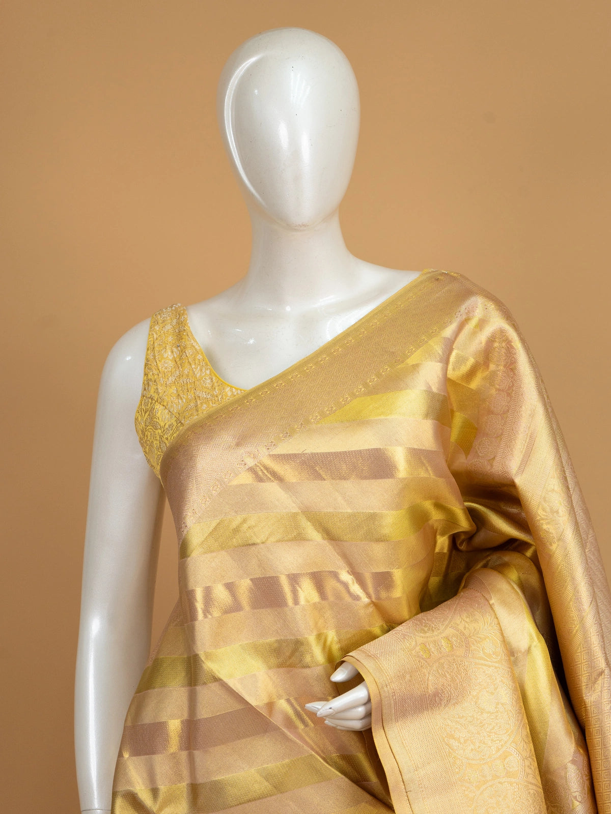 Gold and cream pure Kanchipuram silk saree with diagonal gold zari stripes and an ornate floral zari border