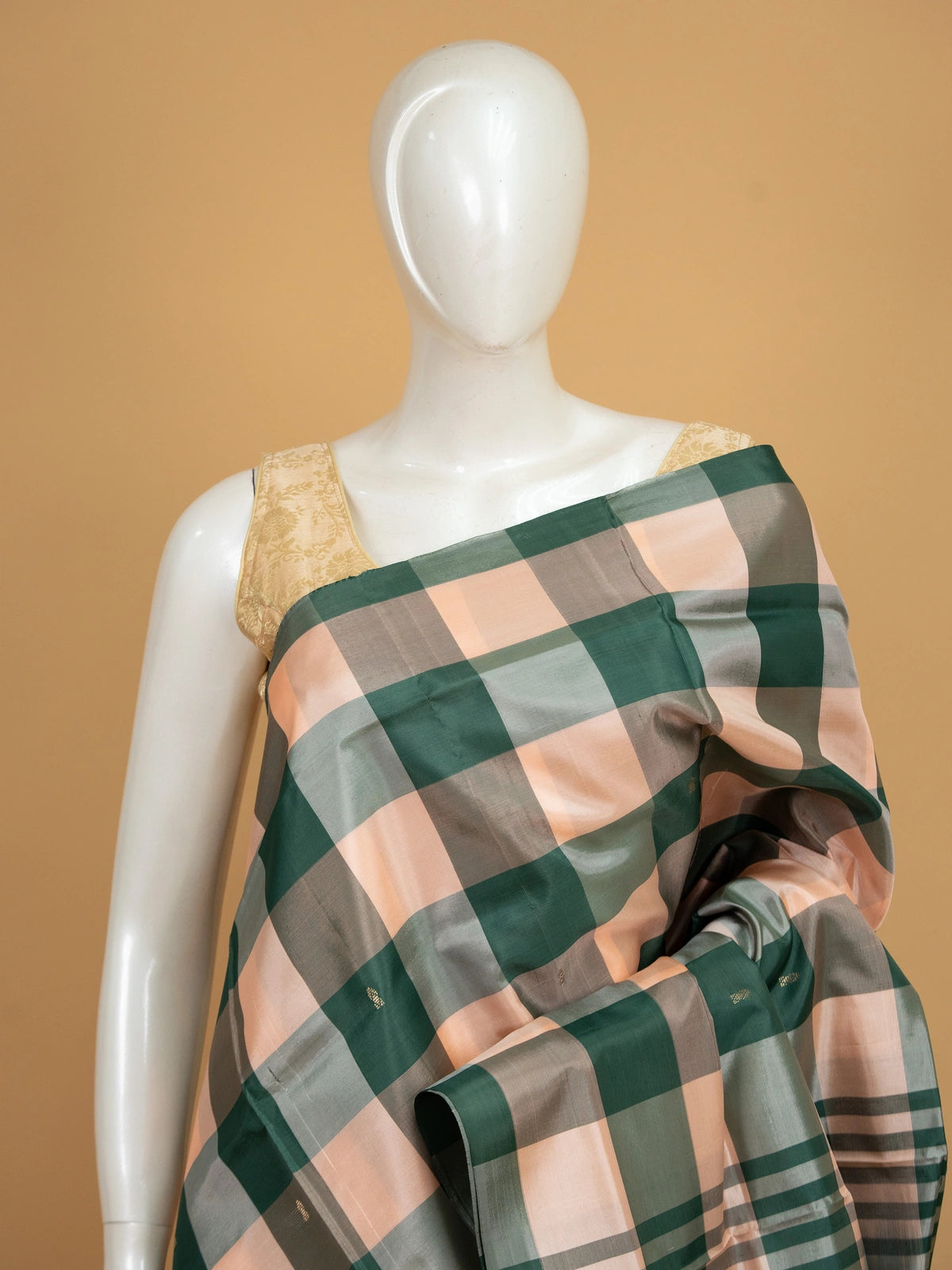 Green and peach checked banana silk saree with dark green zari pallu and border