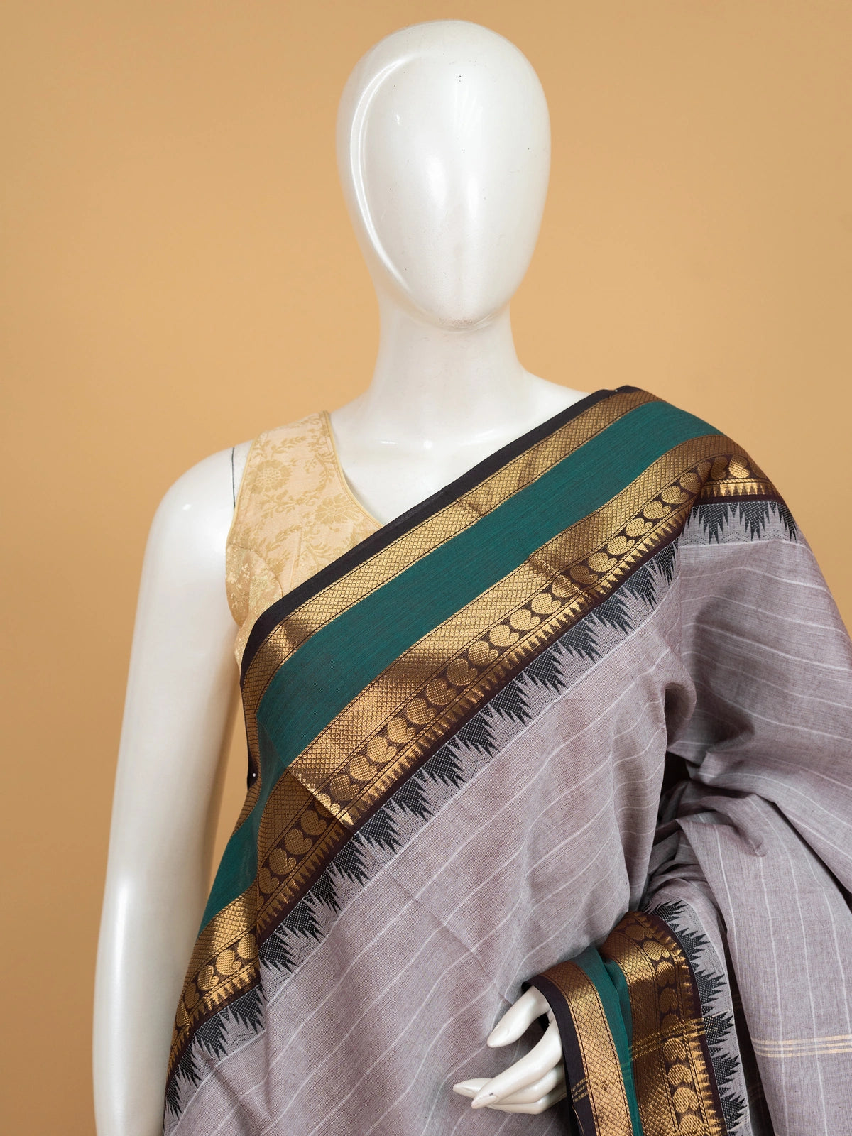 Grey Chettinad cotton saree with white checks and contrast green gold zari temple border