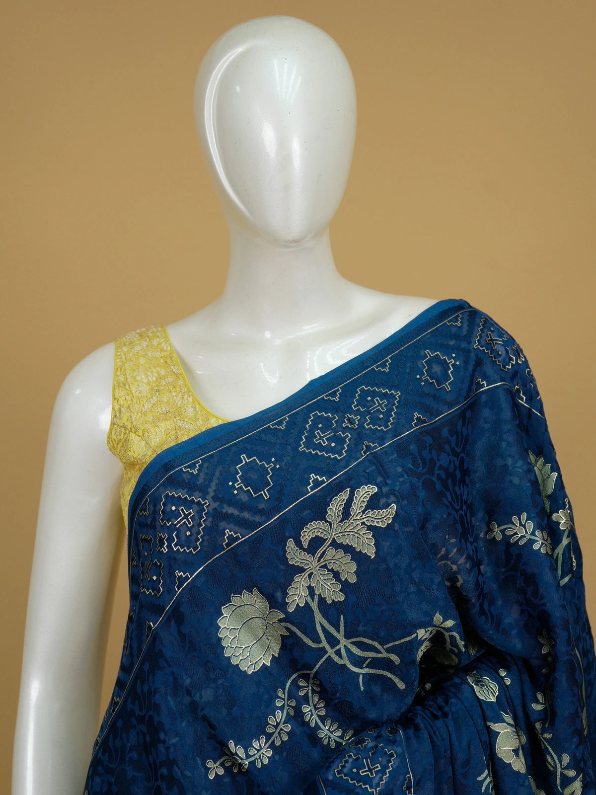 Navy blue and gold designer saree with floral lotus motifs and geometric border