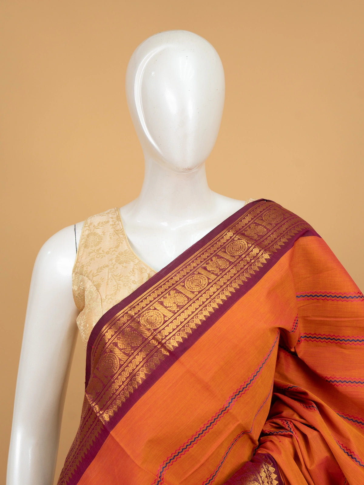 Rust orange Chettinad cotton saree with magenta gold zari border and pink-blue zigzag stripes