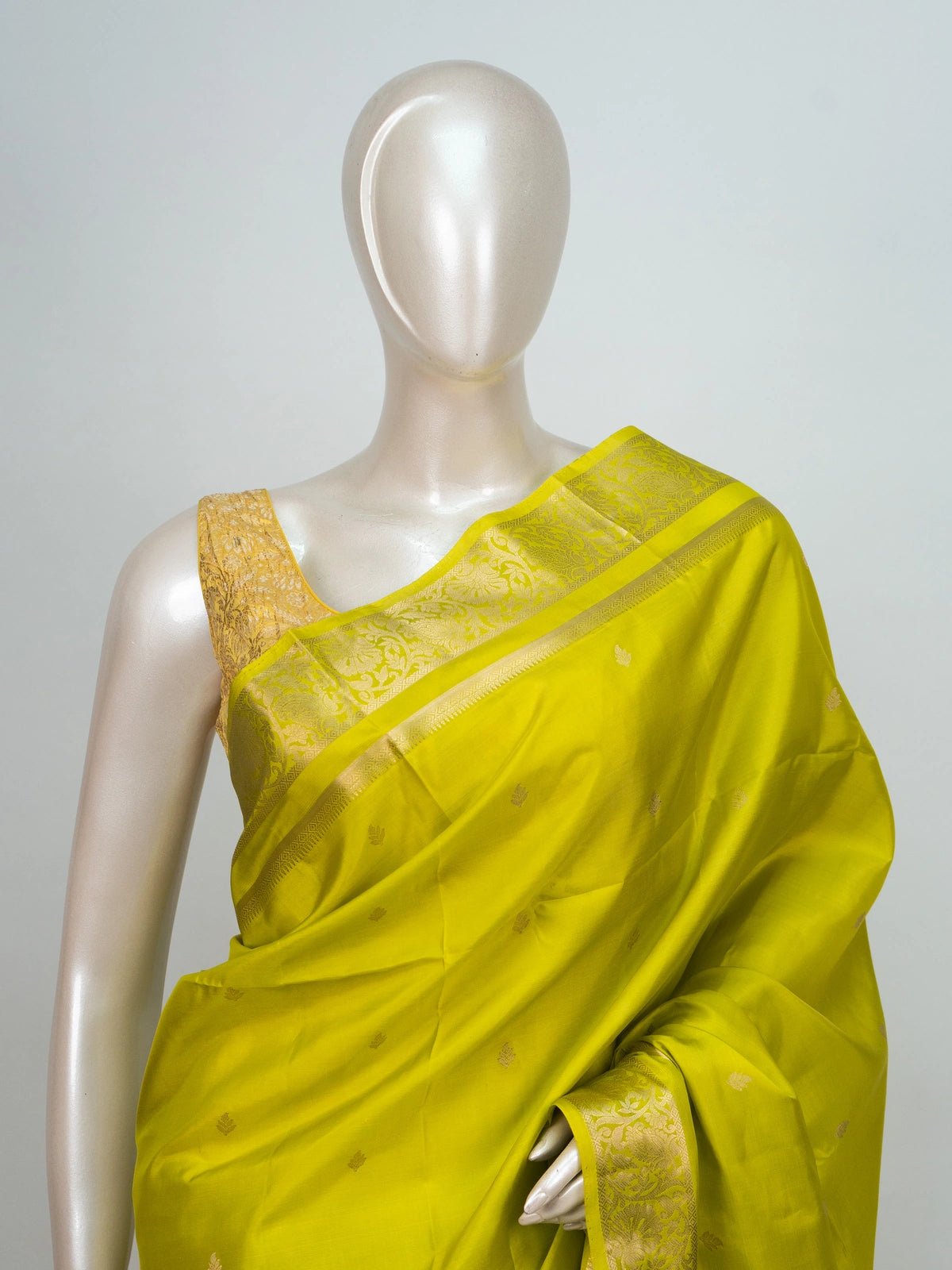 Lime green soft silk saree with broad gold zari border and ornate zari pallu