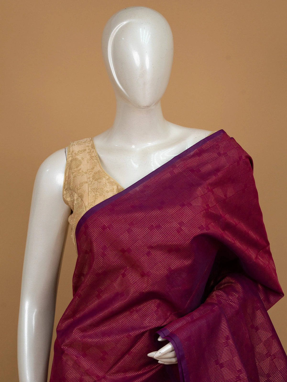 Magenta silk cotton saree with gold zari stripes and contrast blue zari border and pallu