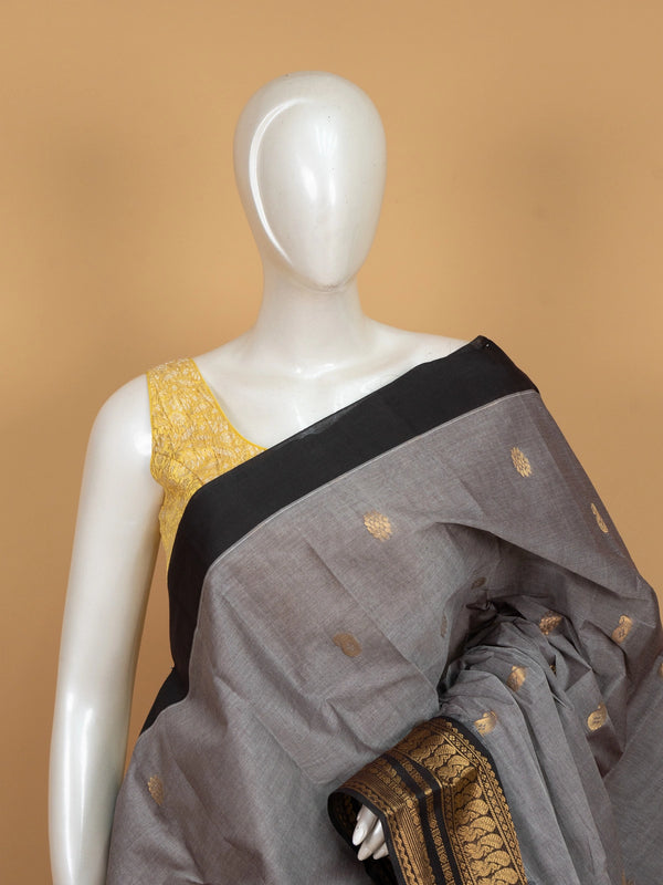 Grey Chettinad cotton saree with black contrast border and gold zari paisley buttas