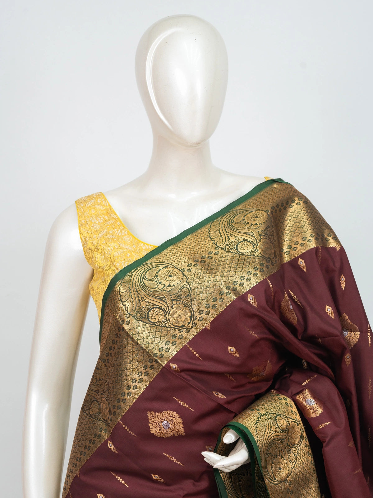 Maroon semi silk saree with gold zari buttas and a contrast teal zari border and pallu