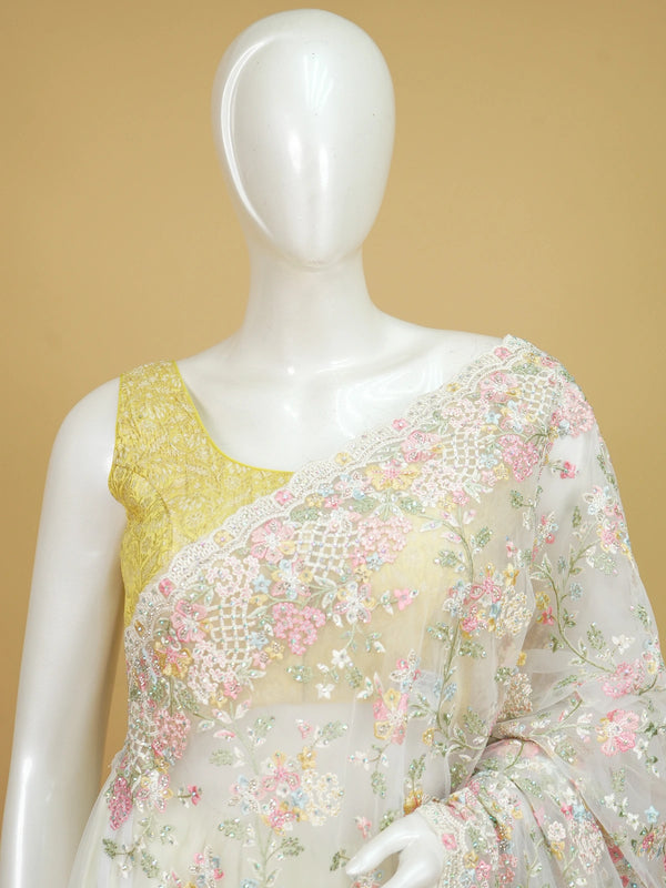Cream net designer saree with pastel multicolour floral embroidery and scalloped border