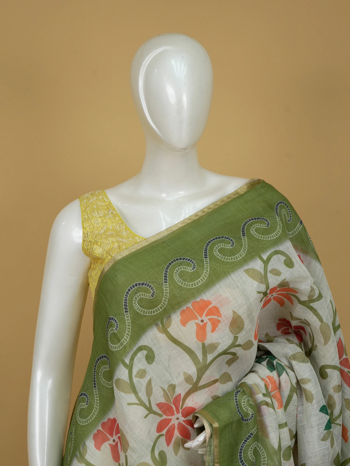 Cream linen cotton saree with floral print, green scrollwork border and paisley pallu