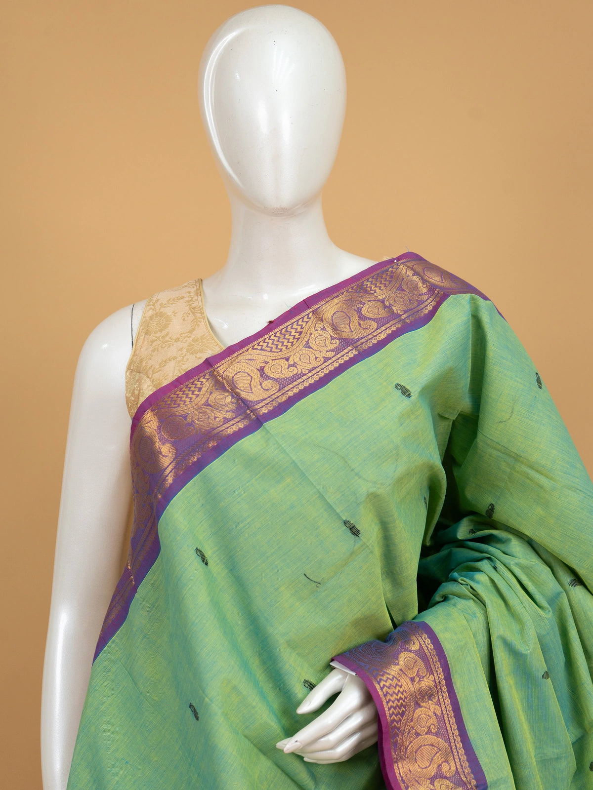 Green Chettinad cotton saree with purple gold zari paisley border and yellow-striped pallu