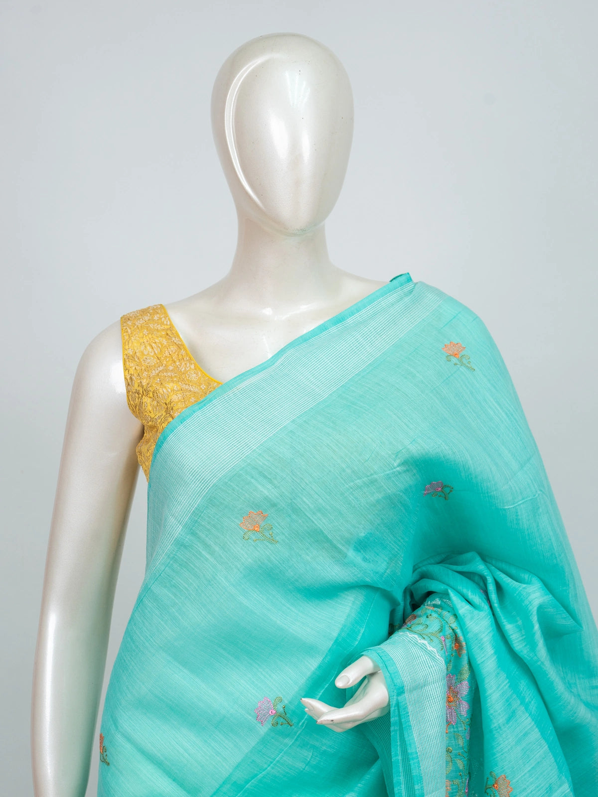 Aqua turquoise linen cotton saree with floral embroidery buttis, silver zari border and embroidered floral pallu