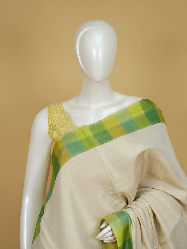 Cream linen cotton saree with green and yellow checked border and pallu