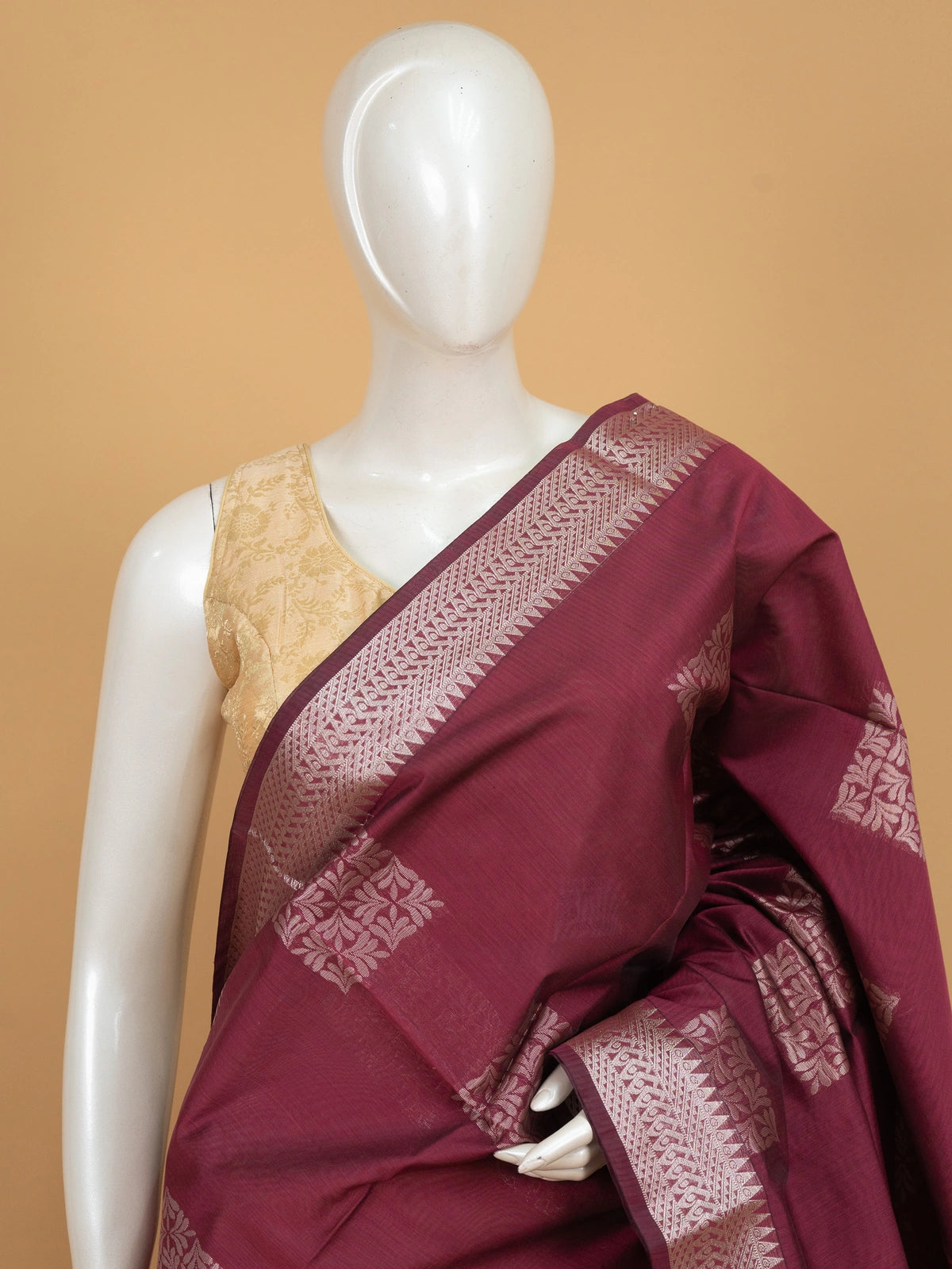 Maroon silk cotton saree with silver zari buttas and contrast woven border