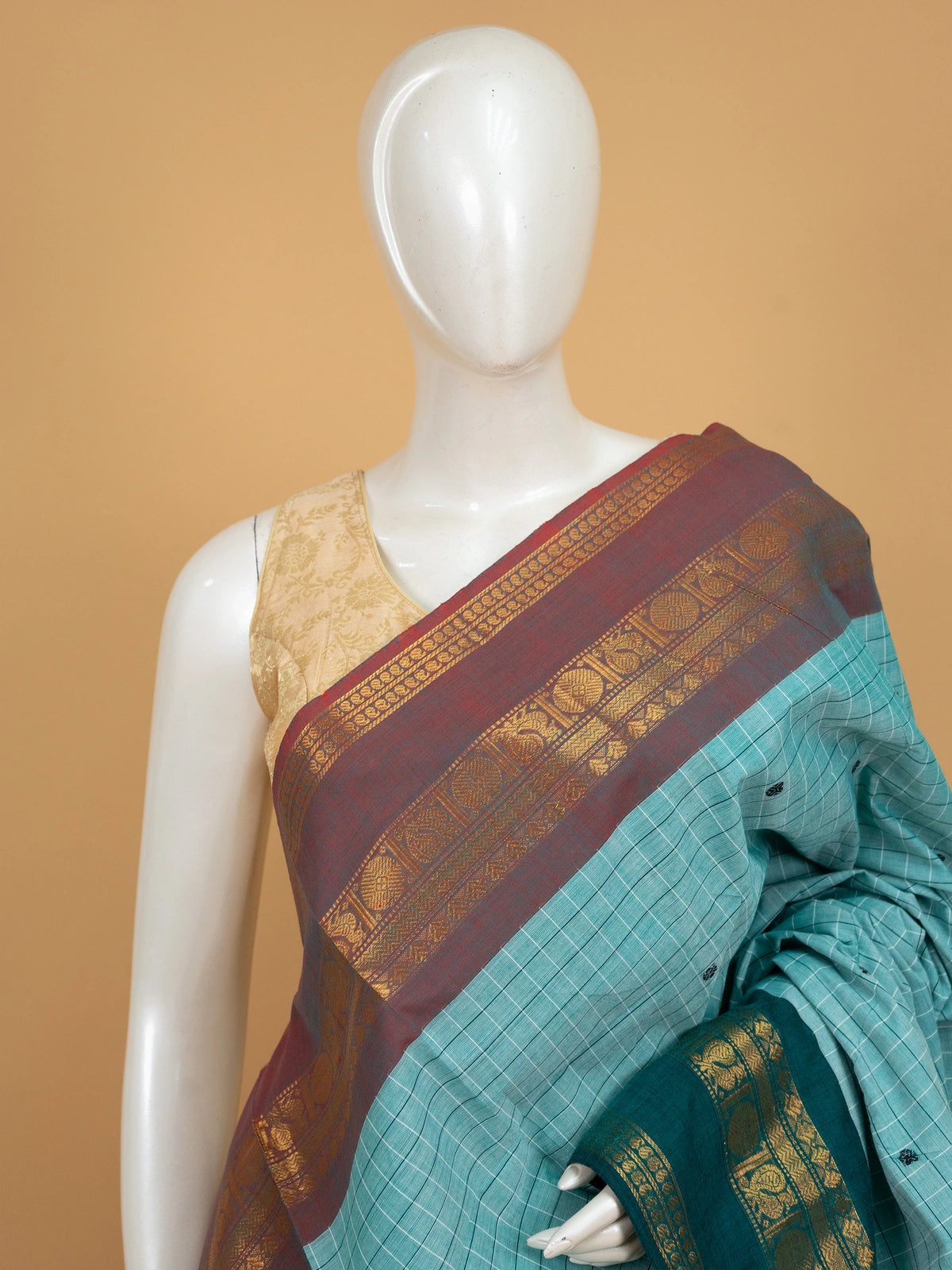 Aqua sea green Chettinad cotton saree with checks, contrast maroon gold zari border and teal peacock pallu