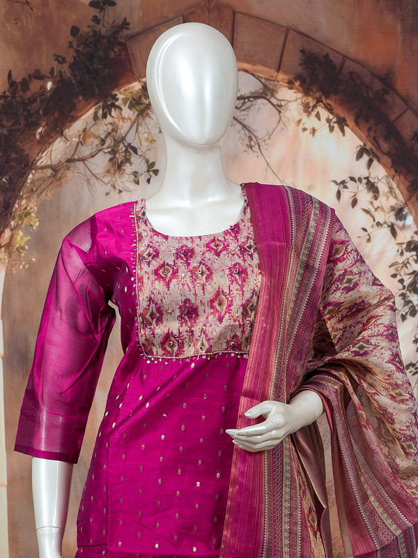 Magenta art silk kurti set with ikat-print yoke, zari booties, and matching printed dupatta