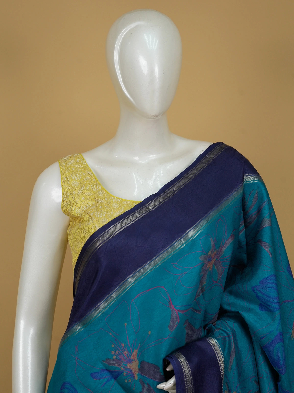 Teal blue Dola silk saree with floral prints, contrast navy zari border and yellow blouse