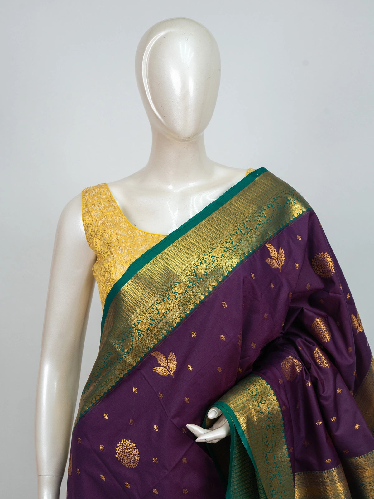 Purple semi silk saree with gold zari butta, contrast green zari border and ornate green-gold pallu