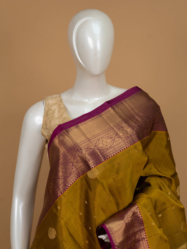 Mehendi green pure Kanchipuram silk saree with magenta contrast border and gold zari pallu
