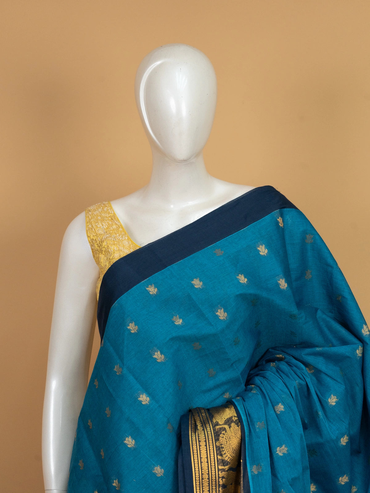 Peacock blue Chettinad cotton saree with gold zari lotus buttas and contrast navy figurative zari border