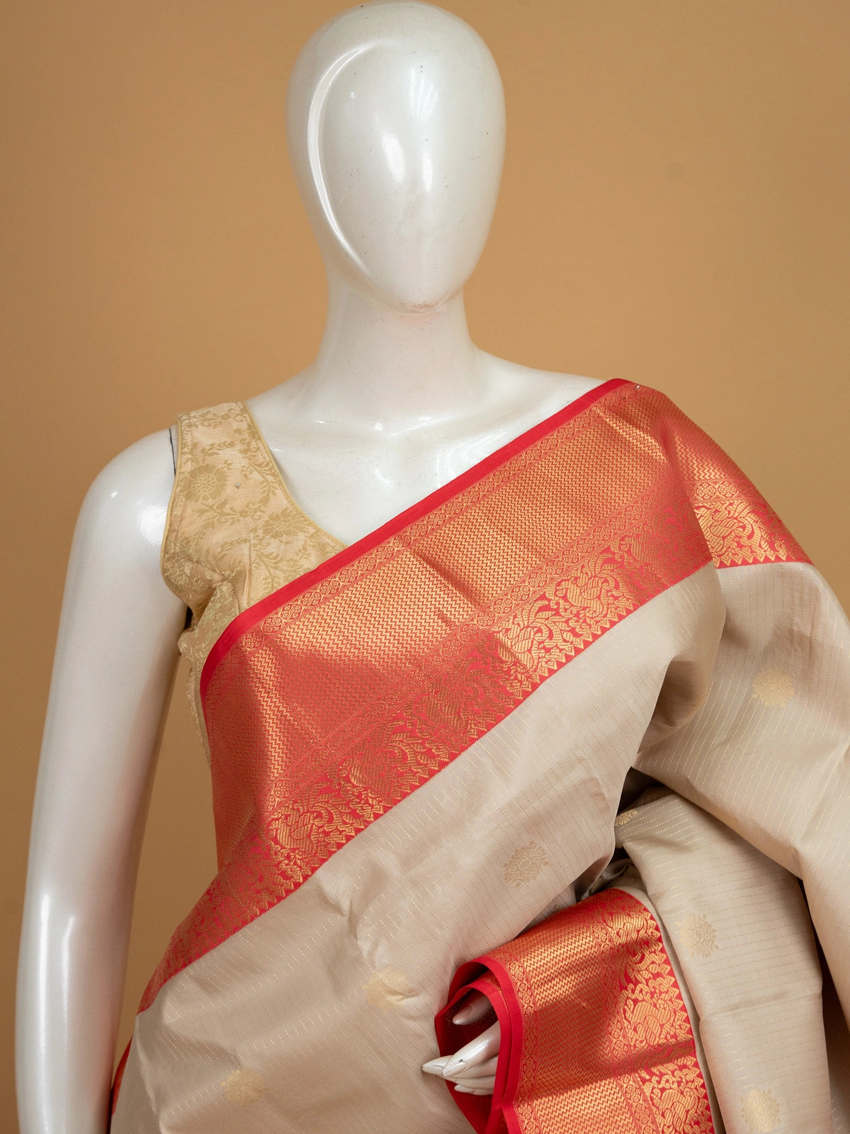 Cream and red pure Kanchipuram silk saree with gold zari border and buttas