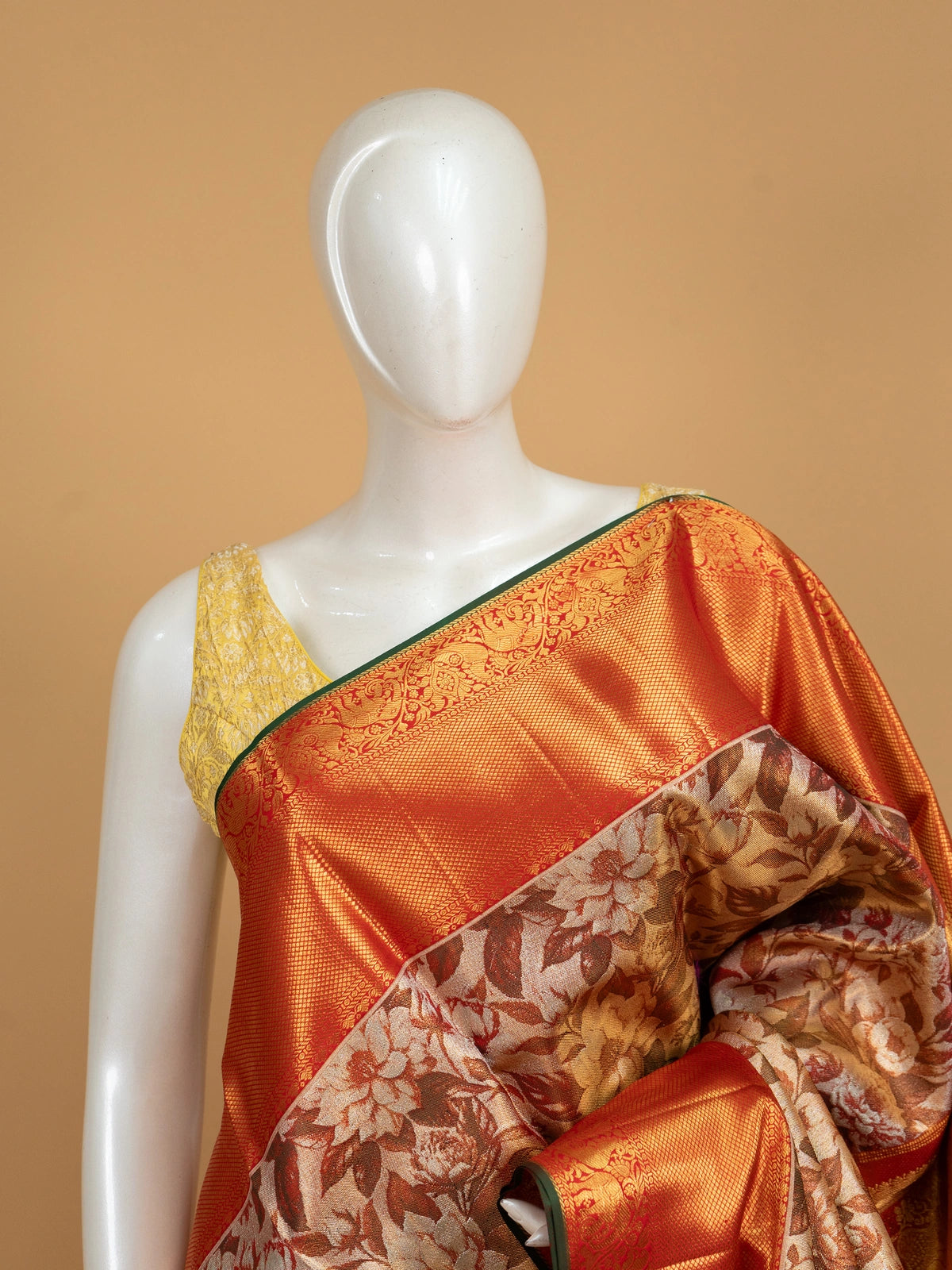 Cream and orange pure Kanchipuram silk saree with floral printed body and gold zari contrast border