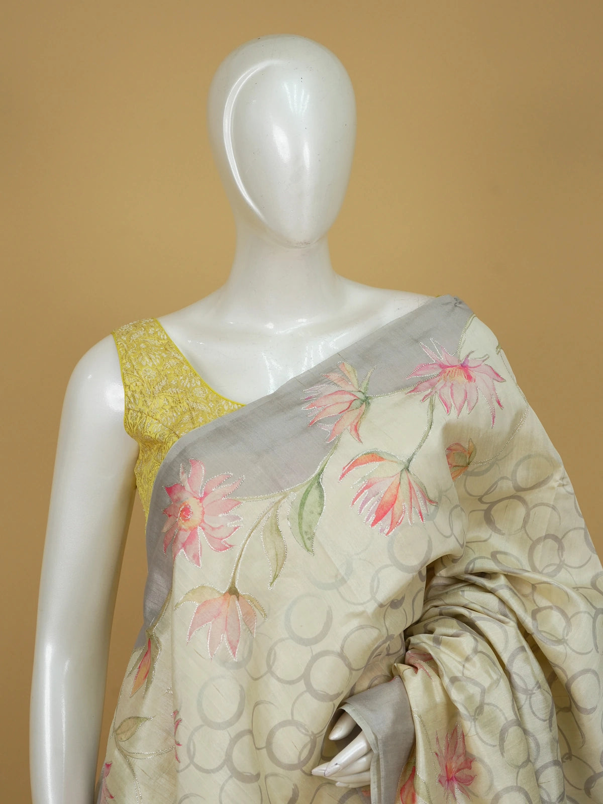 Cream and grey art silk designer saree with hand-painted lotus florals, silver outlining and a contrast grey border