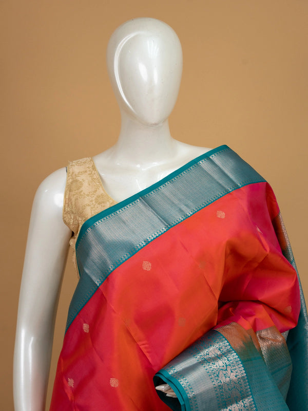 Pink and teal pure Kanchipuram silk saree with silver zari peacock border and gold buttas