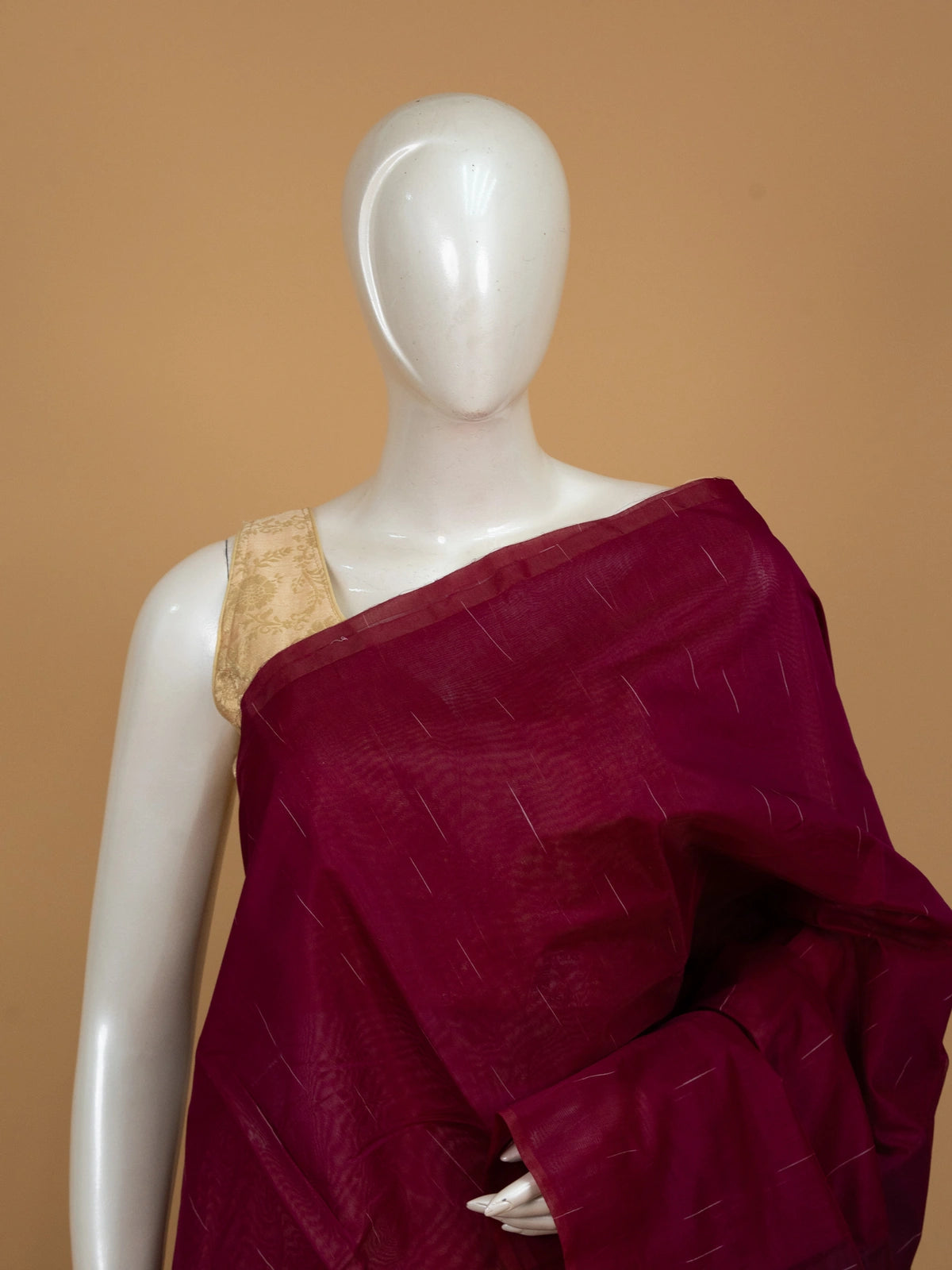 Deep magenta silk cotton saree with fine zari stripes and a dark contrast striped pallu