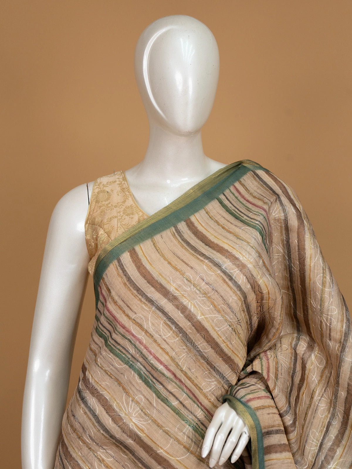 Beige and green linen cotton saree with striped body, floral iris pallu and green zari border