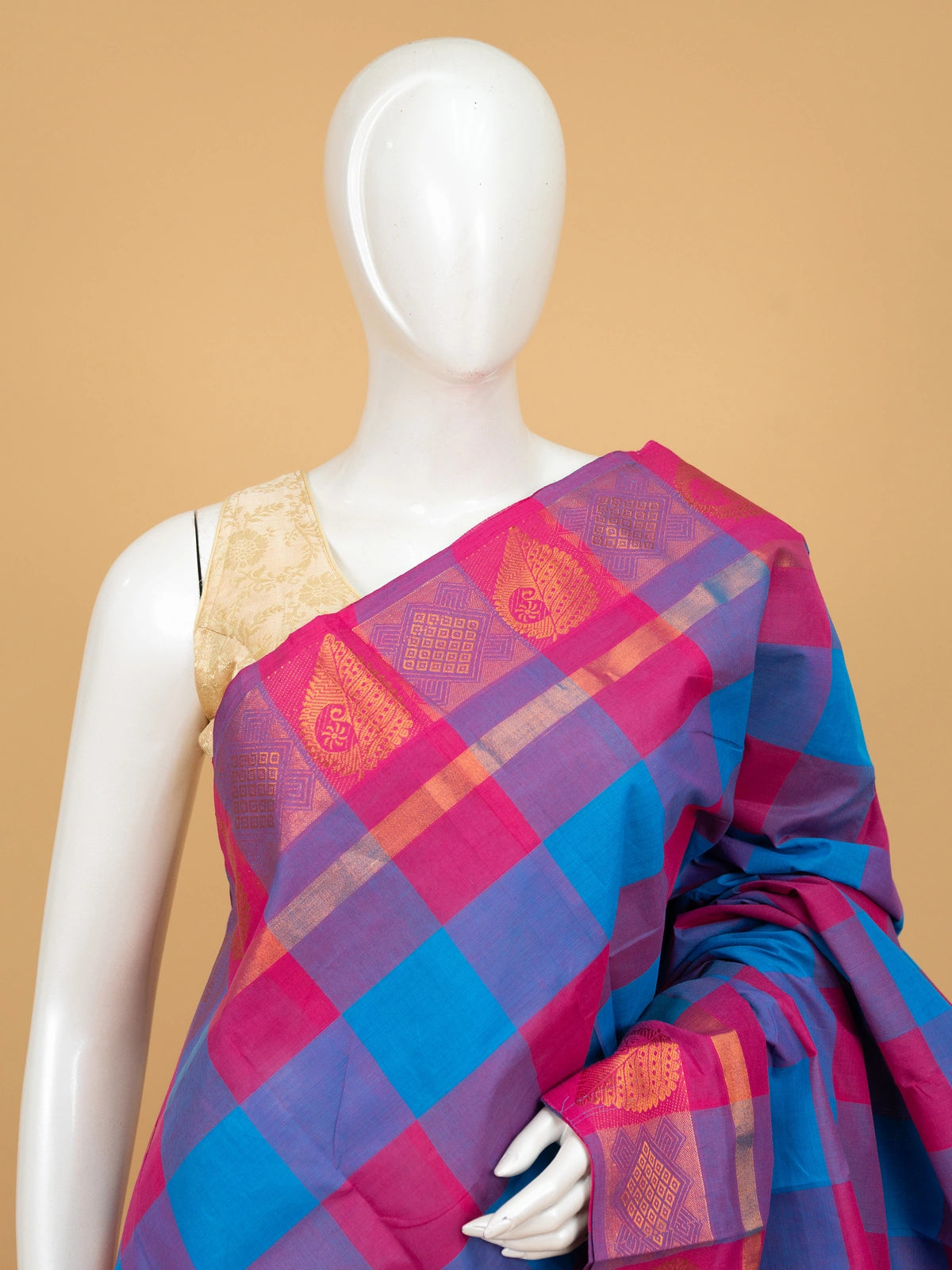 Pink and blue checked Chettinad cotton saree with gold zari border and paisley motif pallu