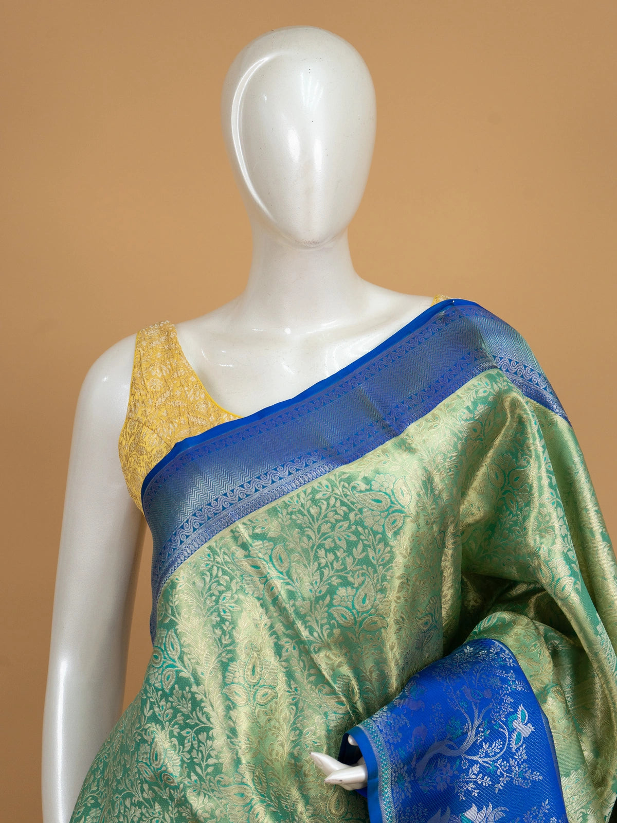 Green pure Kanchipuram silk saree with gold zari brocade and contrast royal blue peacock-motif border