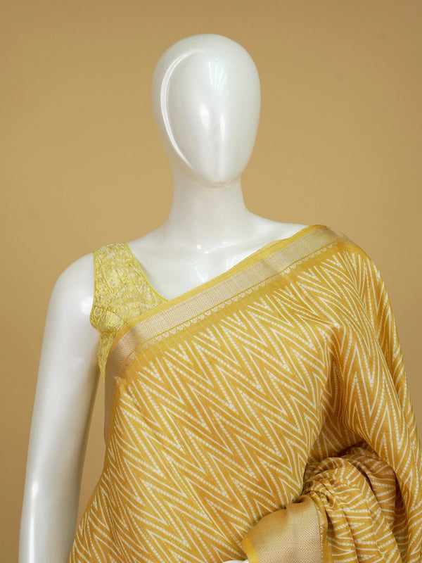 Yellow and white designer saree with zigzag print, gold zari border and tree motif pallu