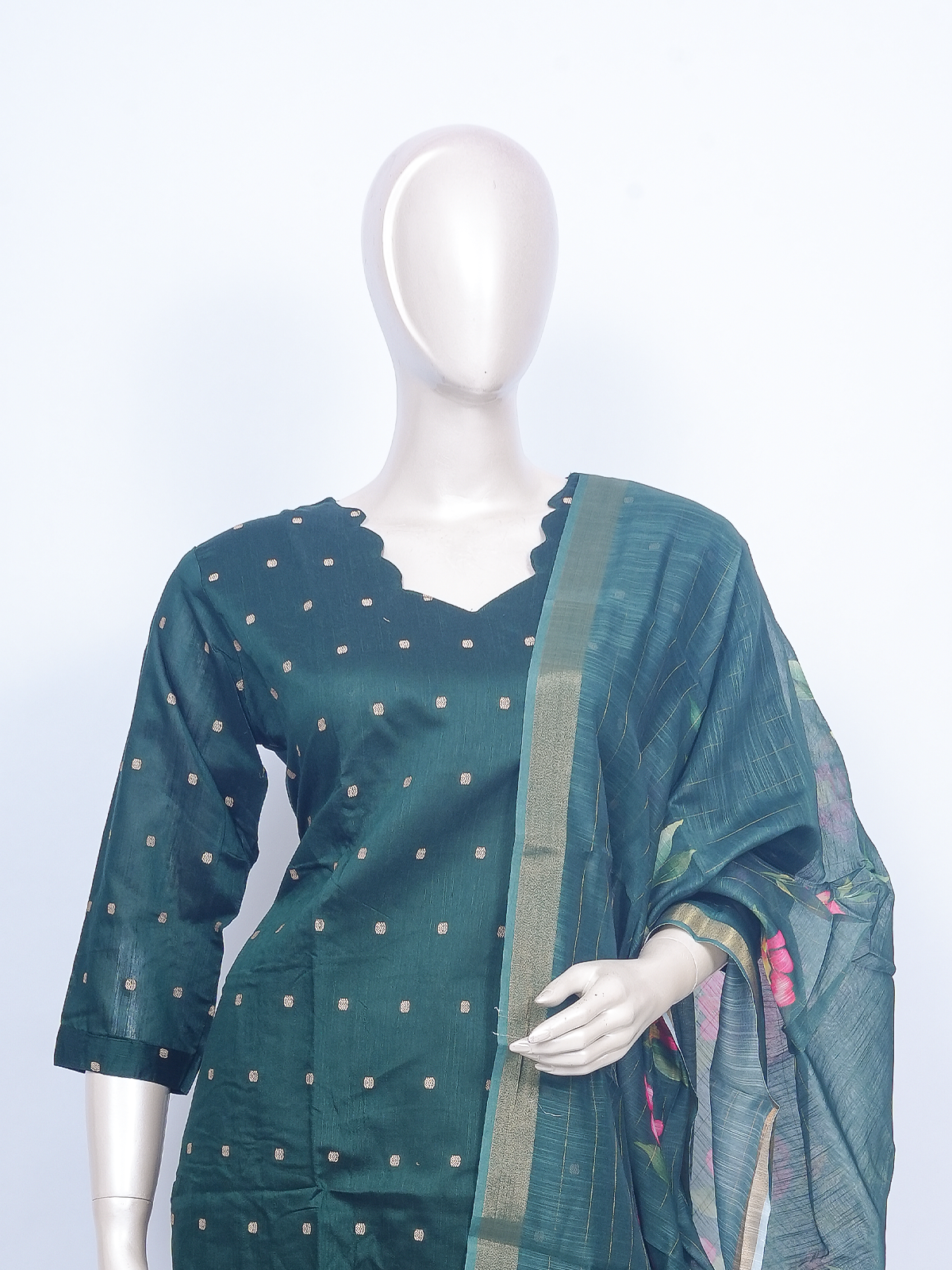 Deep green buti kurti set with beige pants and green floral printed zari-border dupatta