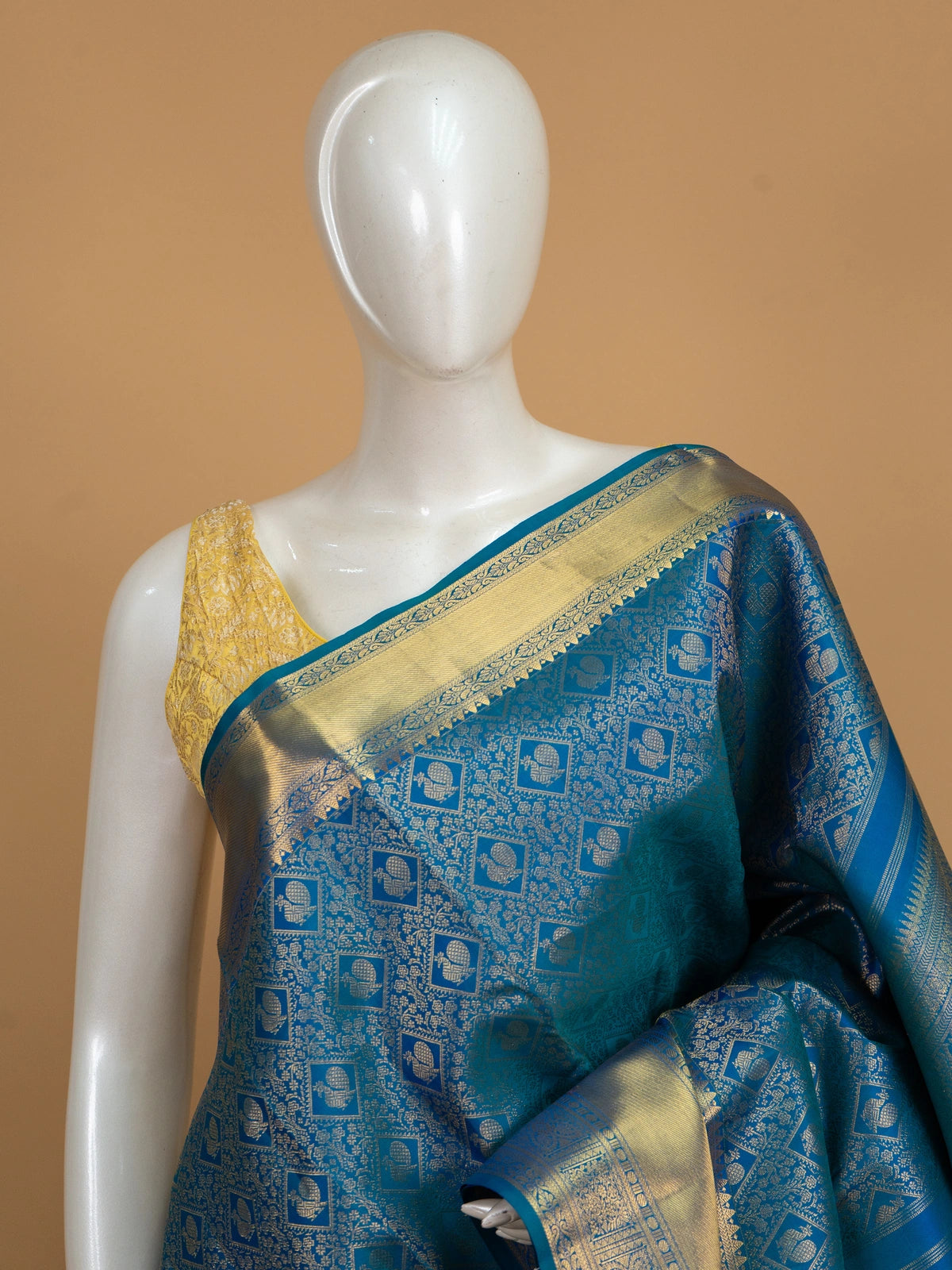 Peacock blue pure Kanchipuram silk saree with all-over gold zari brocade, peacock motifs and broad contrast gold zari border