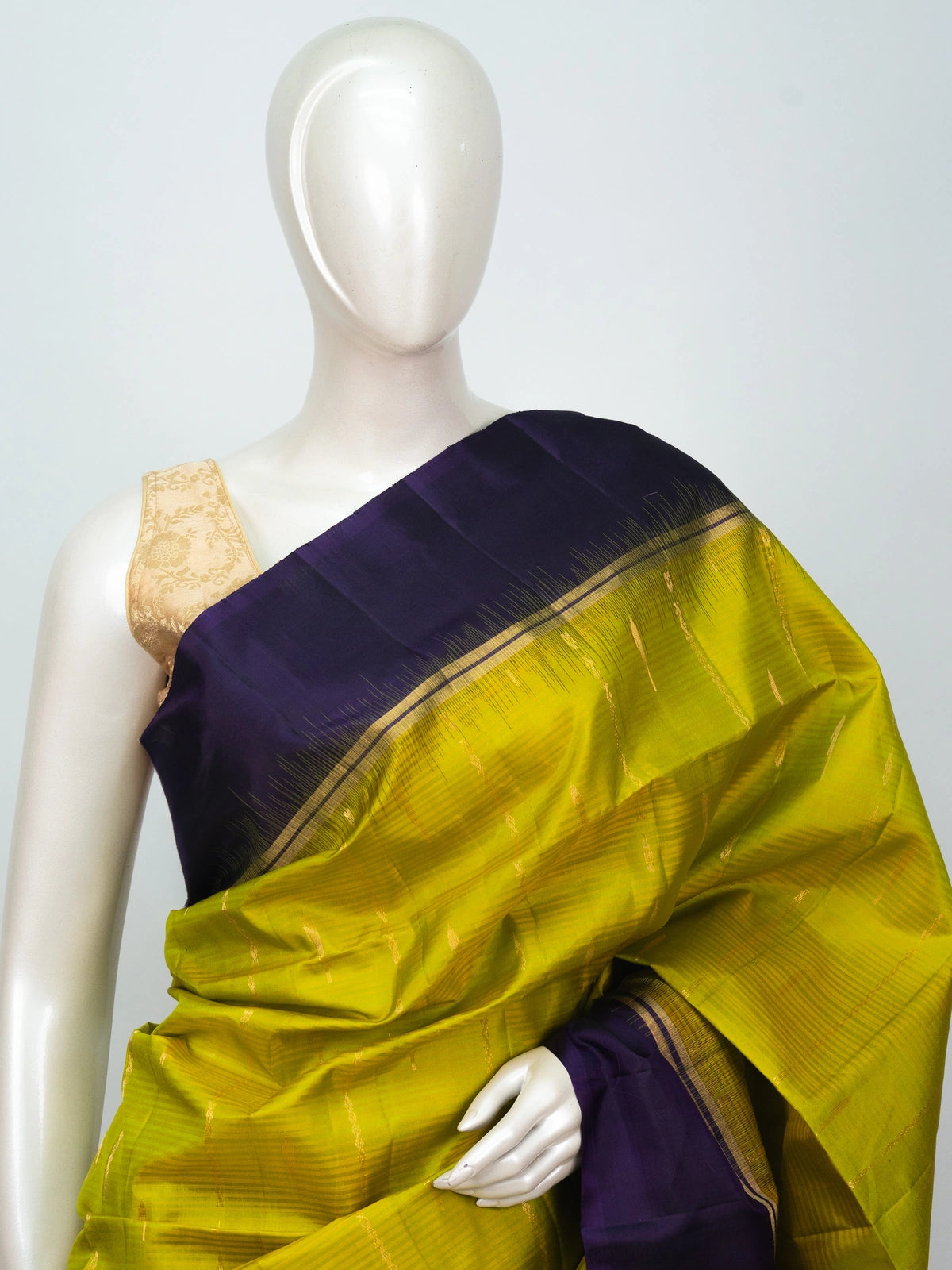 Lime green soft silk saree with purple contrast border and gold zari pallu