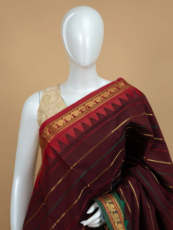 Maroon Chettinad cotton saree with gold zari stripes and green temple border