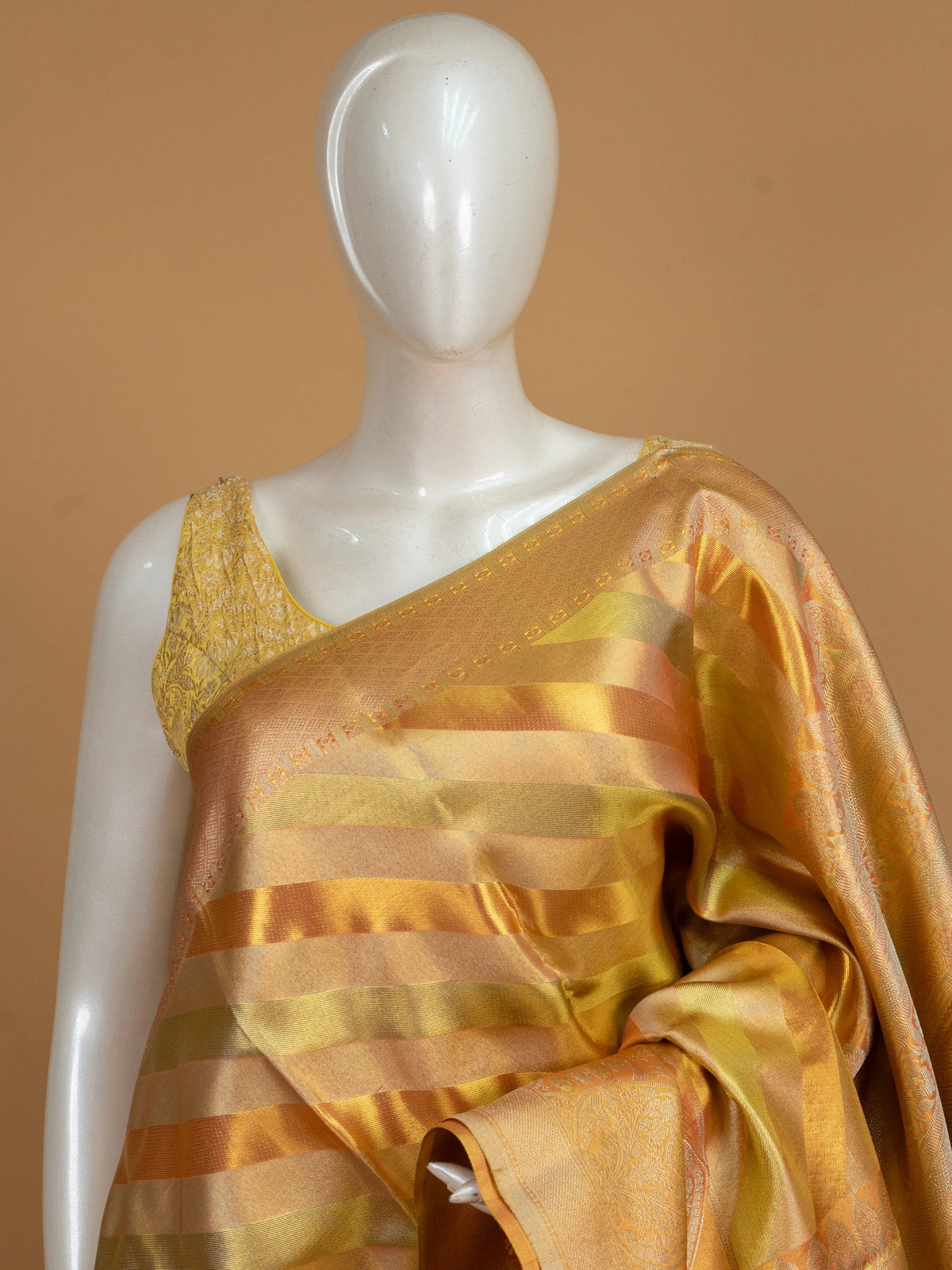 Gold and orange pure Kanchipuram silk saree with diagonal zari stripes and floral zari border
