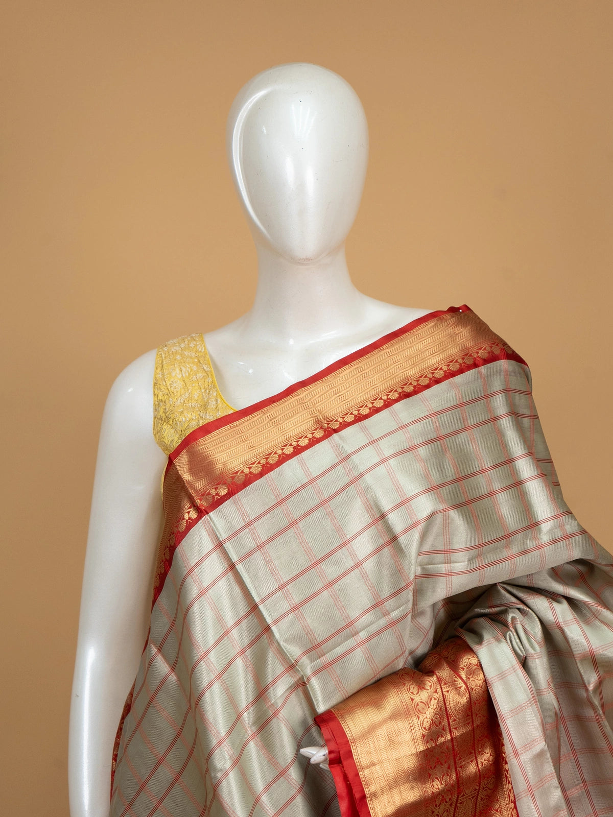 Grey and red checked Kanchi semi silk saree with gold zari border and peach pallu