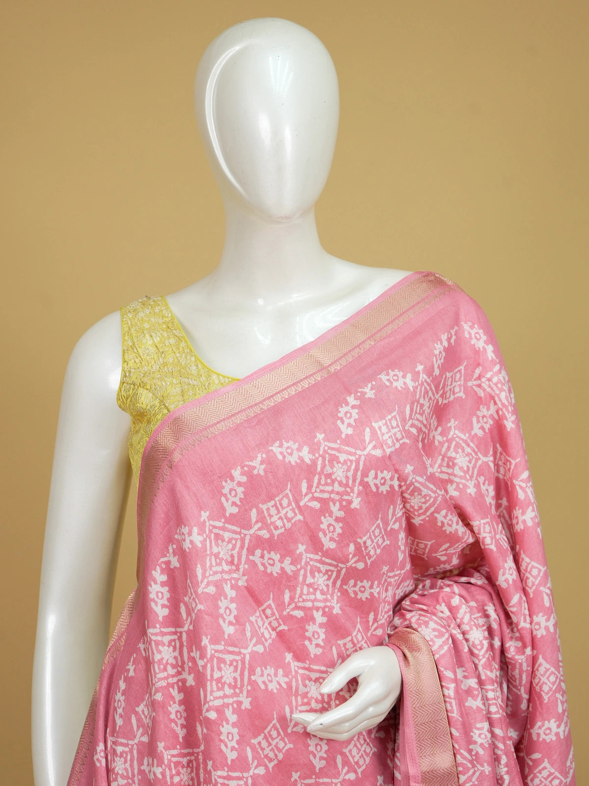 Pink and white batik-print designer cotton saree with gold zari border
