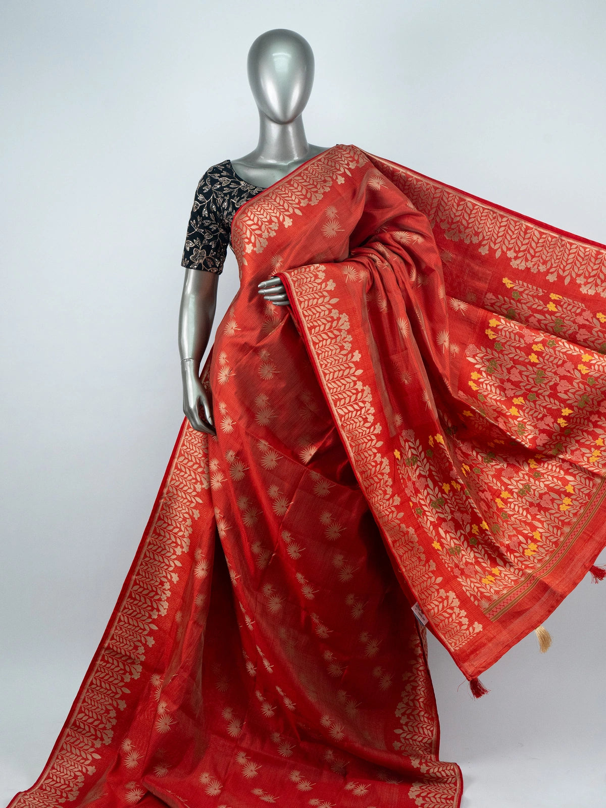 Red semi raw silk saree with gold zari butas, leaf-vine border and multicoloured floral pallu