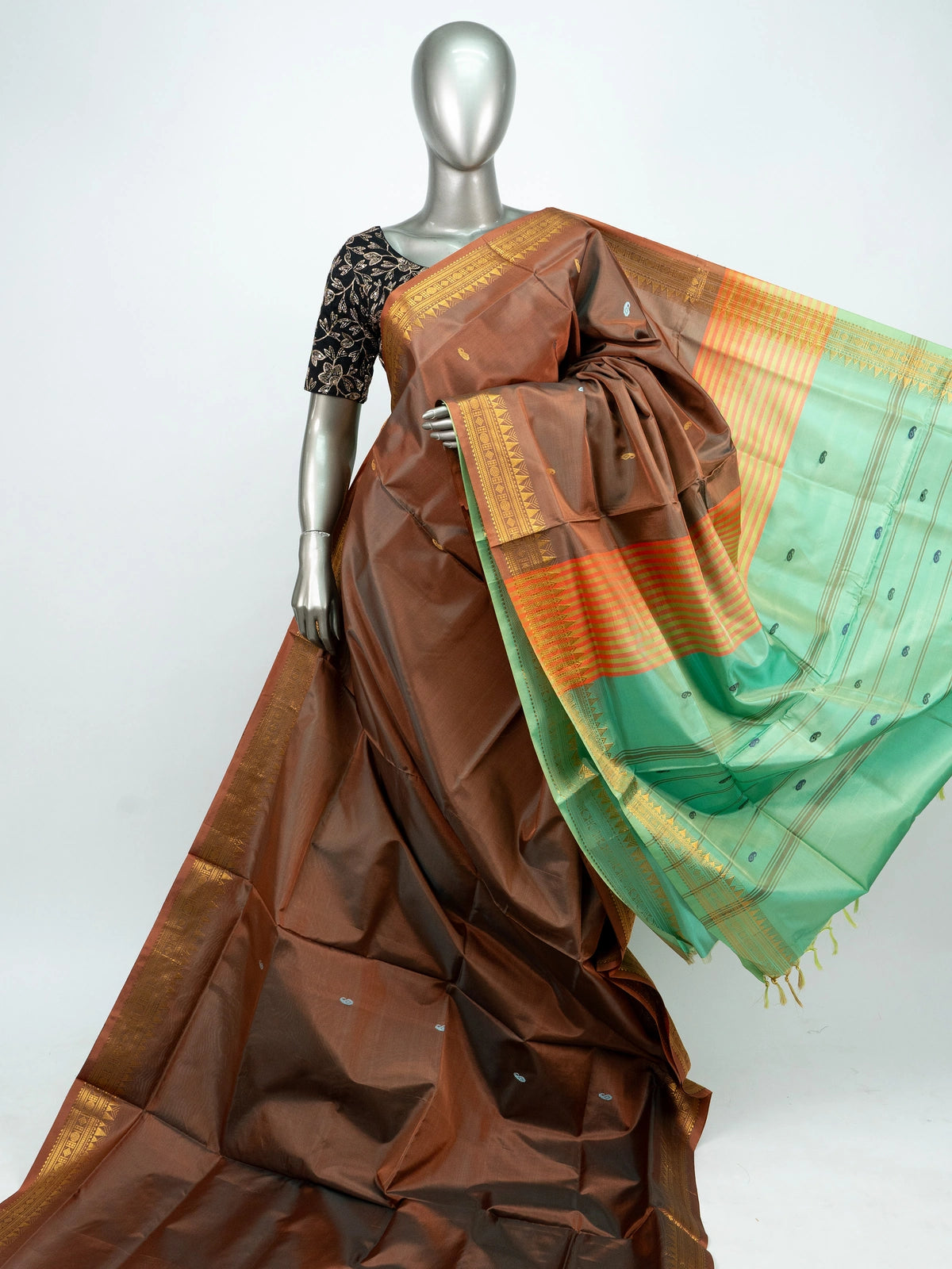 Brown banana silk saree with gold zari border and contrast green striped pallu