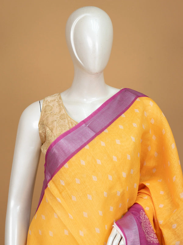 Yellow linen cotton saree with white diamond buttas and contrast pink border and pallu