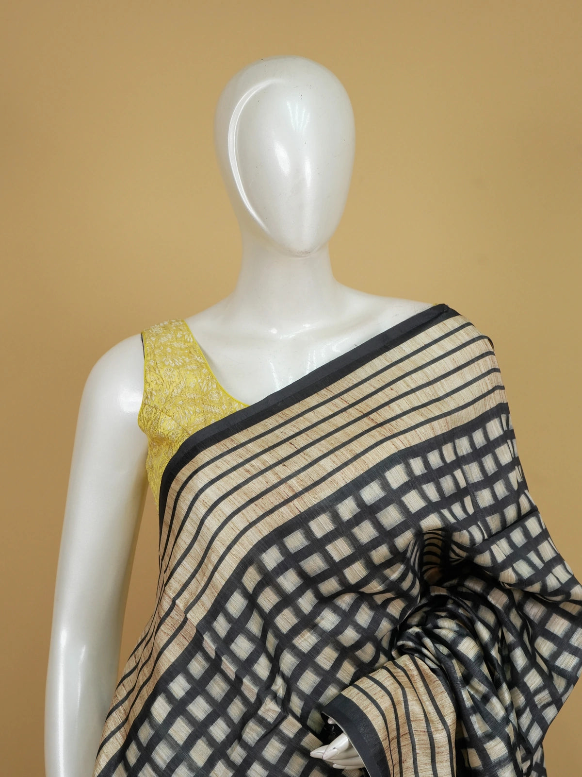 Beige and black checked semi tussar saree with black border and Kalamkari-style bird and floral pallu