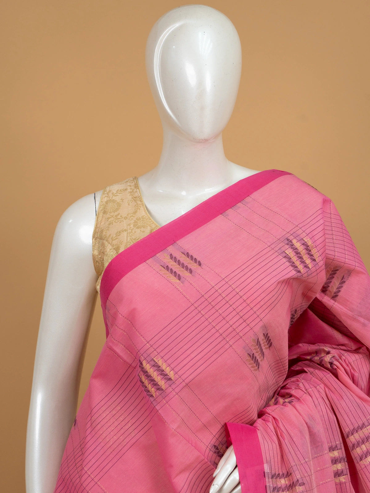 Pink silk cotton saree with magenta contrast border, gold zari buta motifs and woven paisley pallu